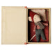 Maileg Christmas Mouse Baby tucked into its red bed inside the open storybook box