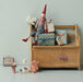 Maileg Christmas mice and pixies playing around a wooden bench with wrapped gifts