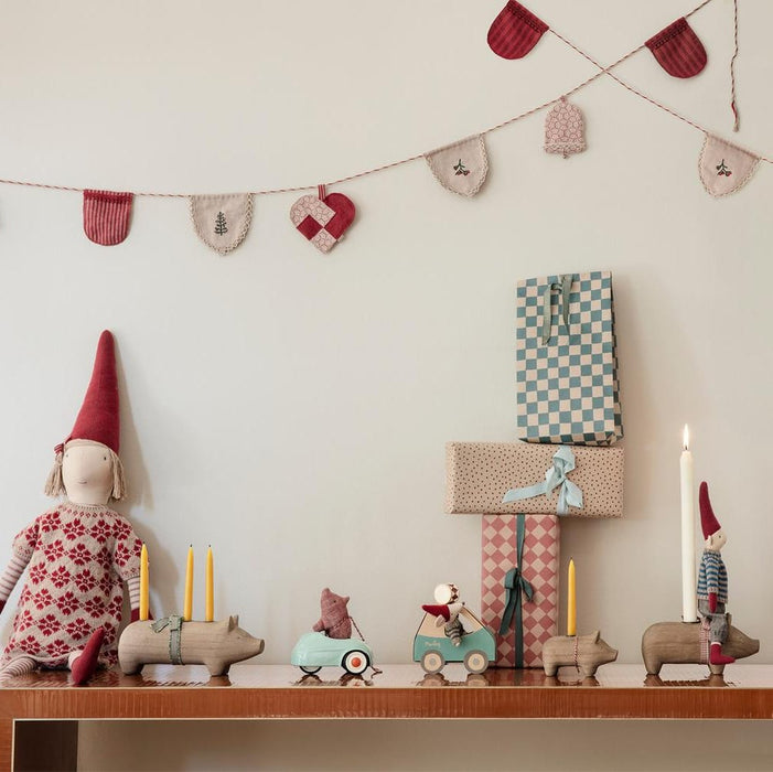 Maileg Little Brother mouse in his green car on a Christmas shelf with candles and gifts
