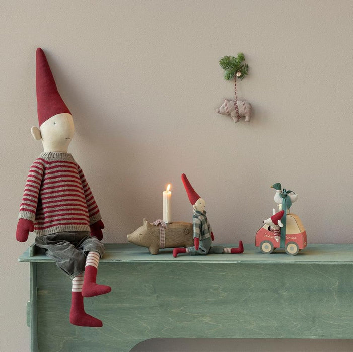Maileg Little Sister mouse in her red car on a festive shelf with a pixie and candle