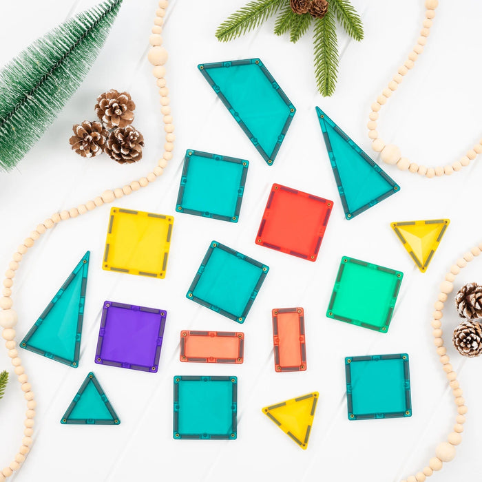 All 16 Connetix Christmas Tree Pack tiles laid out among pine cones