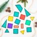 All 16 Connetix Christmas Tree Pack tiles laid out among pine cones