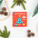 Connetix Christmas Tree Pack box surrounded by pine branches and pine cones