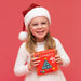 Girl in a Santa hat smiling with the Connetix Christmas Tree Pack