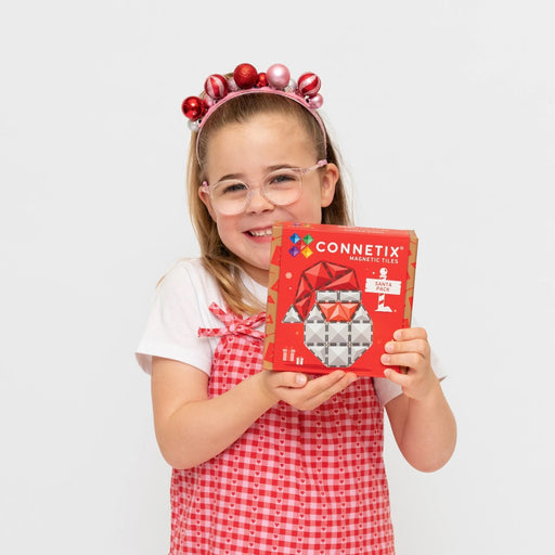 Girl holding the Connetix Christmas Santa Pack box