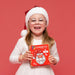 Girl in a Santa hat smiling with the Connetix Christmas Santa Pack