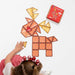Child building a reindeer from pastel Connetix magnetic tiles beside the pack