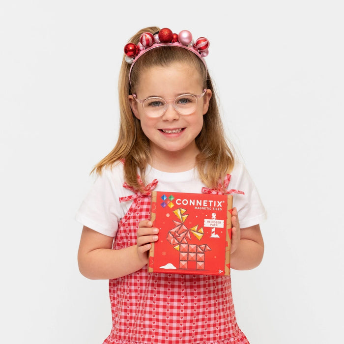 Girl holding the Connetix Christmas Reindeer Pack box