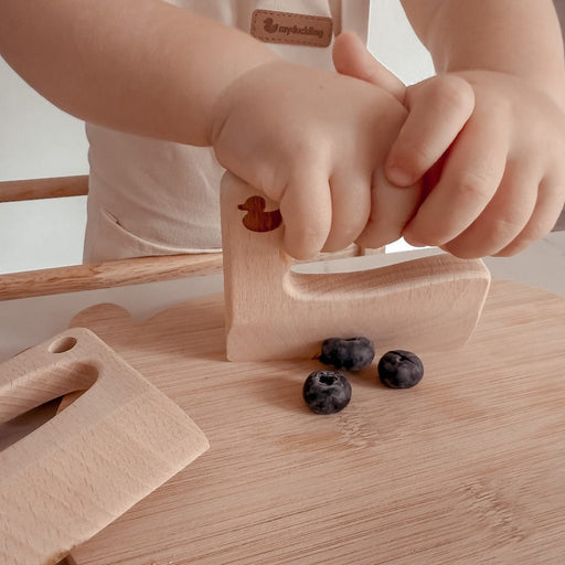 Toddler cutting blueberries with a myduckling wooden kids knife
