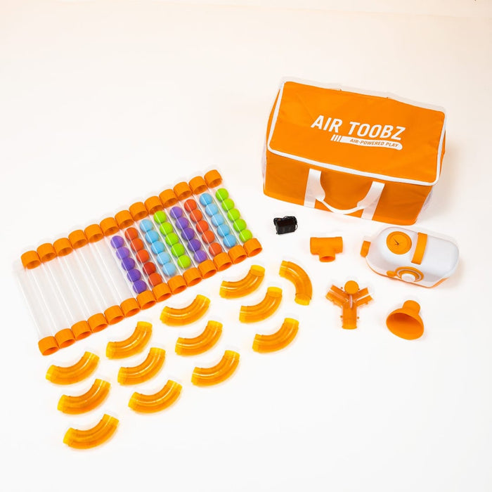 Air Toobz tubes, corner pieces, connectors, balls and fan arranged in front of the carry bag